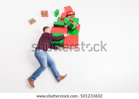 Black Friday 2016 at United States! Funny father holding many gift boxes for kids and running. Copy space at white background. Big gift box! Cristmas shopping. Xmas, New Year holiday! Merry Christmas!