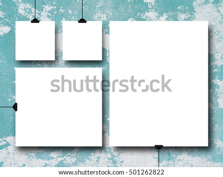 Four blank square and rectangular frames on aqua scratched plastered wall background