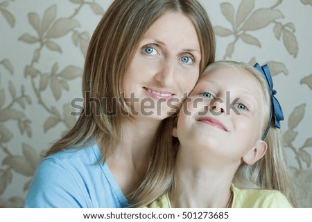 Family portrait of happy mother with her teenage daughter