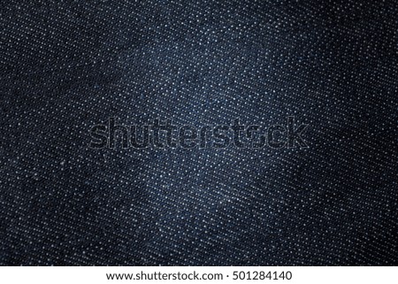 Denim jeans with dark blue shade. Texture for background.