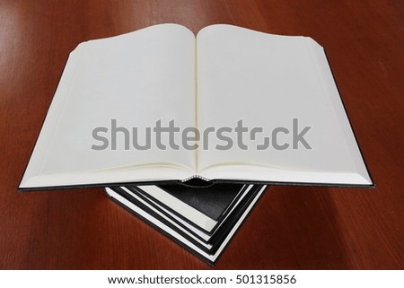 open book.stack of book on the wooden table
