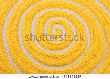 The contour of concentric circles drawn with a finger on corn grits, horizontal photo