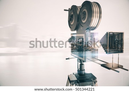 Retro movie camera on abstract city background with copy space. Double exposure. Cinema concept