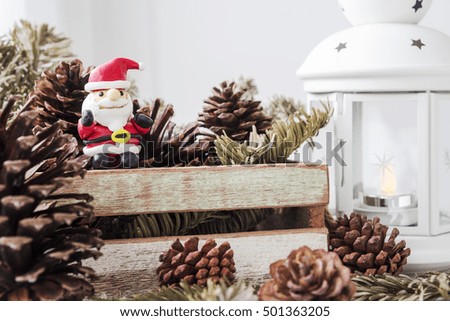 Christmas decoration of santa claus and pine cones on wooden cabinet