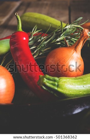 Different kind of local vegitables on the wooden rustic table. Organic food concept. Toned picture