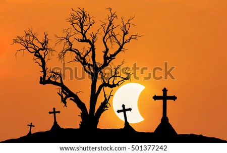 Halloween concept background with scary silhouette dead tree and spooky silhouette crosses in mystic graveyard with half moon background
