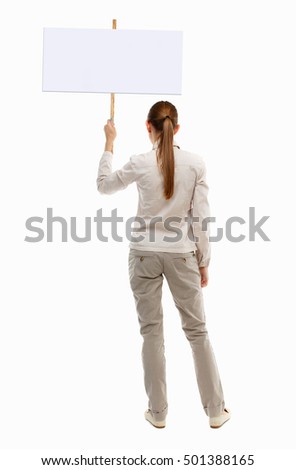 Back view woman. Rear view people collection. backside view of person. Isolated over white background. girl in gray jacket holds poster above his head
