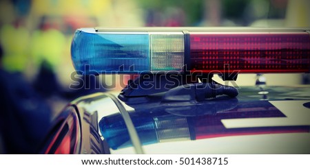 red and blue flashing lights of the police car at the checkpoint in the city Royalty-Free Stock Photo #501438715