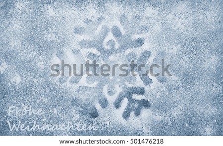 Snowflake, grey fiber fabric, blue glitter film and the words Frohe Weihnachten (german words for Merry Christmas)
