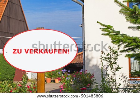 For Sale text  in German on big house with farm yard background