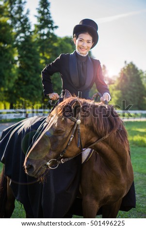 Asian girl riding her horse at her stables