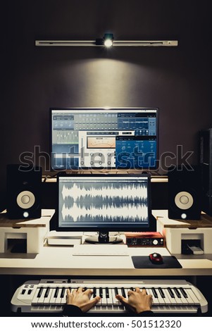 sound engineer, composer working in digital editing & recording studio for post production or broadcasting