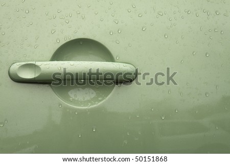 green handle on the door of the car