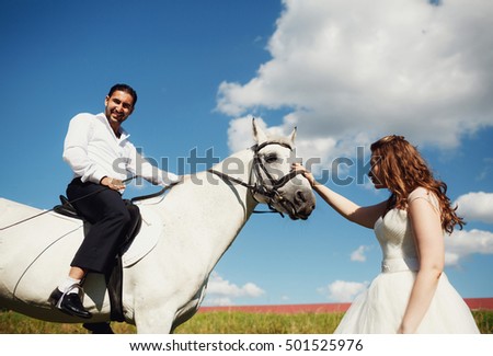 The groom sitting  a horse