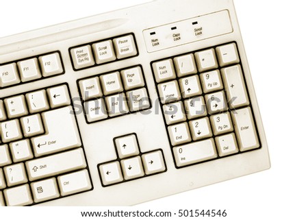 Old computer close-up yellow colored keyboard numbers panel isolated on white background