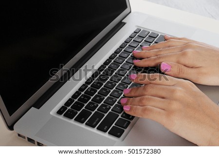 Woman's hands on keyboard closeup on gray background