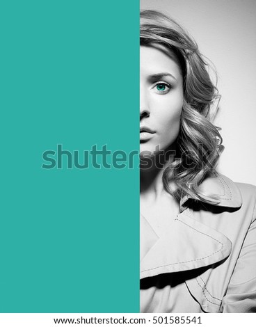 Woman half face young beautiful healthy skin portrait black and white with cyan colorful part for text or design. Appropriate for book covers or movie posters. Depression, fear, sadness. Victim.