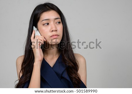 Asian teenager girl talking on mobile phone