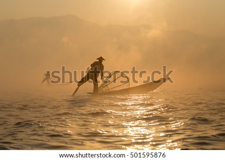 Two fishermen on the lake, foggy cold morning, Inle Lake, Myanmar