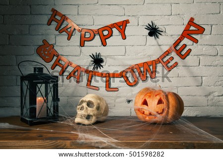 halloween Pumpkin, skull and candle on a wooden table, spiders, spider web background brick wall, happy halloween