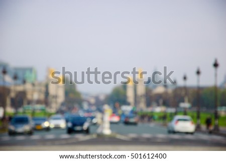 Blurred photo of traffic at Pont Alexandre III. Alexander III Bridge connects Champs-Elysees quarter with Invalides and Eiffel Tower quarters.