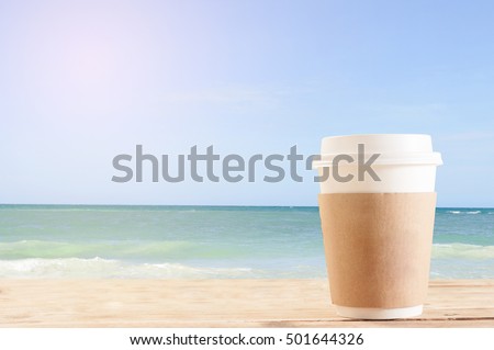 Paper coffee cups for holding back on grunge wooden background