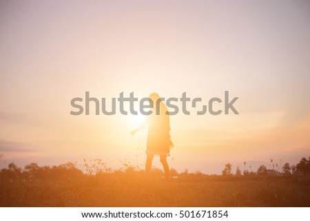 Silhouette of woman against beautiful sky background