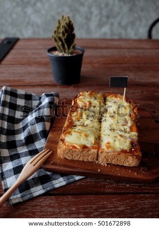 Pizza toasted bread with tomato sauce and ham cheese selective focus, picture vintage style 