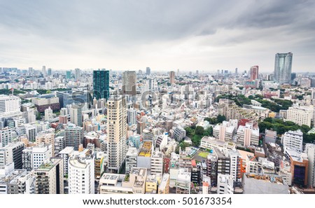 Business and culture concept - panoramic modern city skyline bird eye aerial view from tokyo tower under dramatic grey cloudy sky in Tokyo, Japan