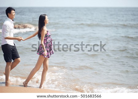 	Couple standing on seaside	 