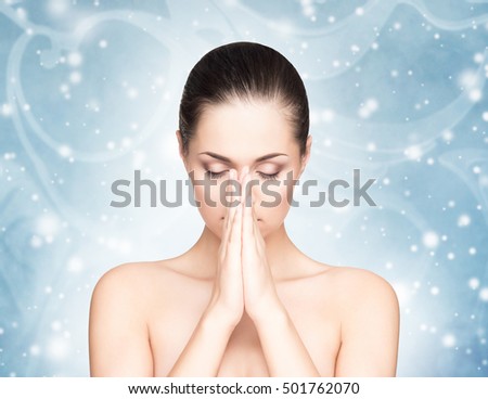 Spa portrait of young and beautiful woman over Christmas background. Face lifting and plastic surgery winter concept.