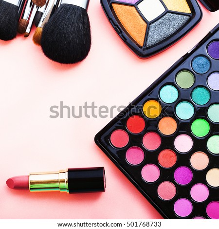 Colorful cosmetics and accessories on pink background. Top view and copy space. Selective focus