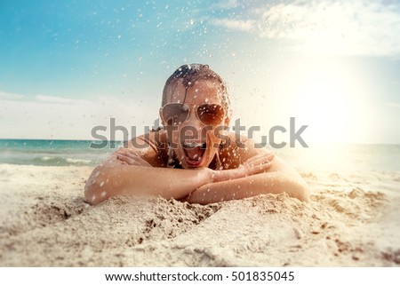 girl enjoying water splash on the beach