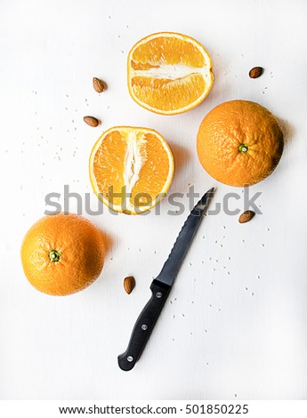 Orange fruit with black knife and nut isolated on white wood background aesthetic picture