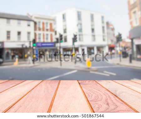 wooden table top over blurred old building and road background in London, can be used for montage or display your products