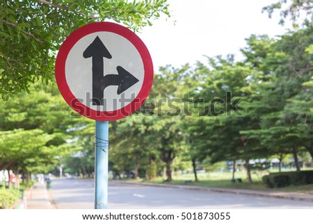  road sign in yellow background and black arrow