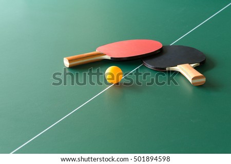 Two table tennis or ping pong rackets and balls on a green table with net
 Royalty-Free Stock Photo #501894598