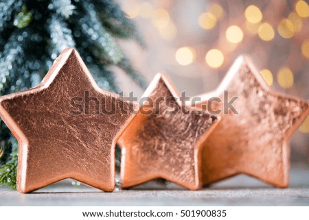 Bronze star decoration. Holiday decorations bronze on bokeh background.