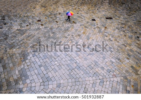 Man walking in the rain with umbrella