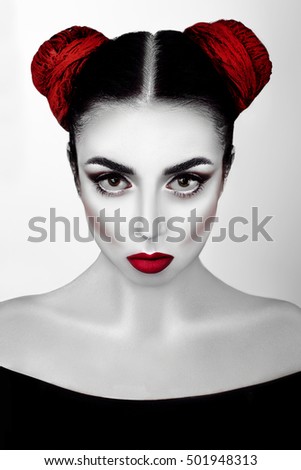 Portrait of a girl in a high fashion, beauty style with white skin, red lips make up at silver background. Vampire makeup Fashion Art design. Halloween holiday concept
