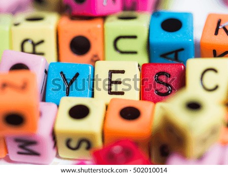 The word "YES" out of colored cubes.
