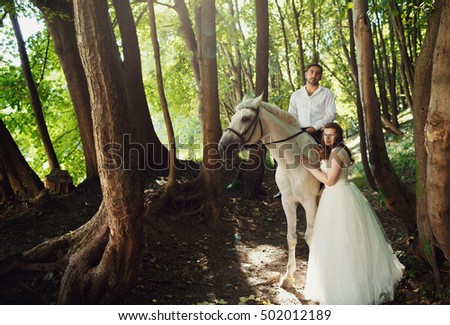 The brides are near horse
