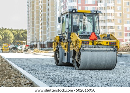 Road roller working at road construction site