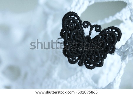 Black lace butterfly on white lace