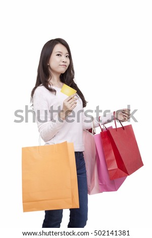 	Portrait of young female holding credit card,withshopping bags	