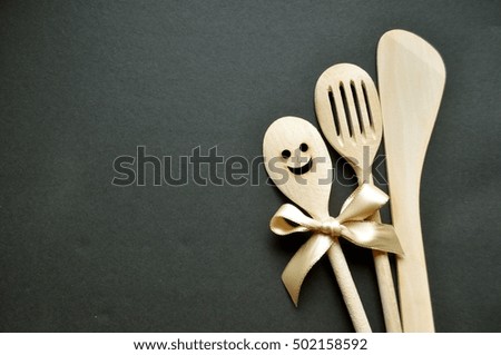 Wooden spoons on a grey background with copy space