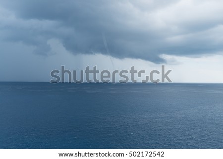Waterspout phenomenon at South China Sea in a stormy weather condition with rain cloud