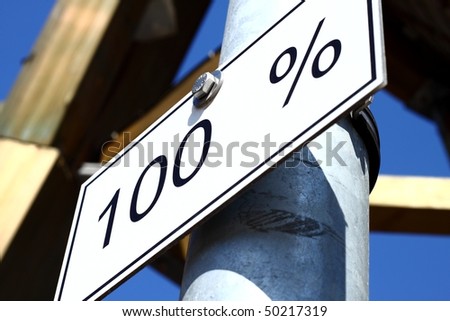 White panel with text "100%" in black color, attached to a steel post