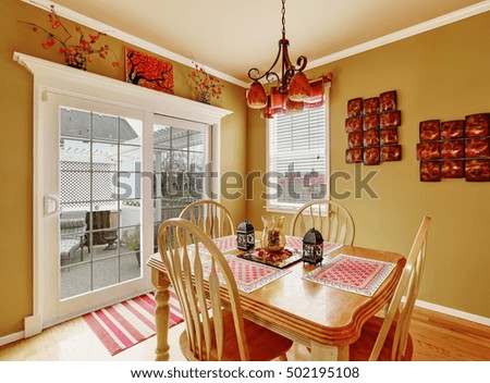 Bright dining room interior in red colors with french door to the back yard. Northwest, USA