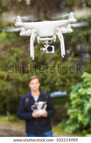 Young man with flying drone. New technology photo and video